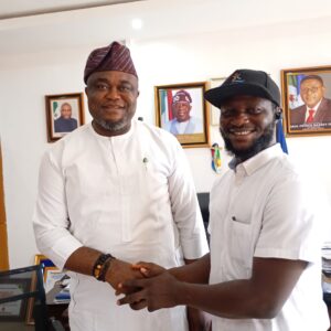 Hon. Erasmus Ekpang, Commissioner for Information in a handshake Jeremiah Abunimye, Artistic Director.