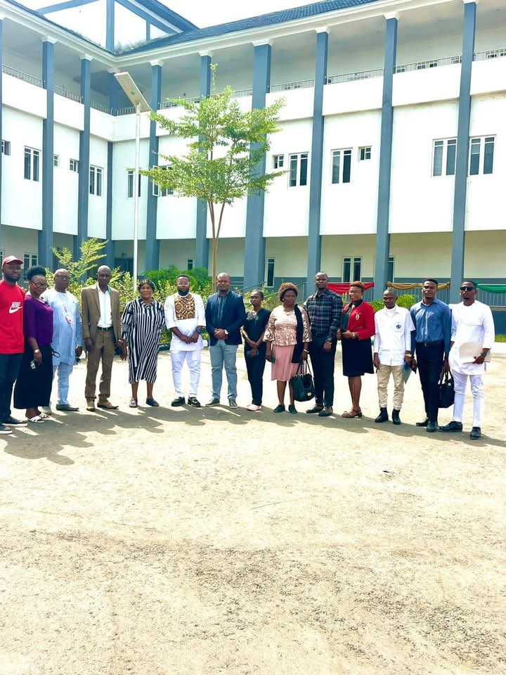 Coco-Bassey Esu in a group photograph with Obudu German hospital management staff