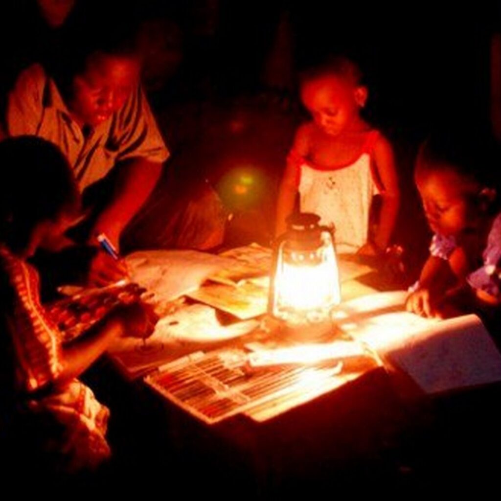 Children reading with a lamp tan-parliamentvanguard.com